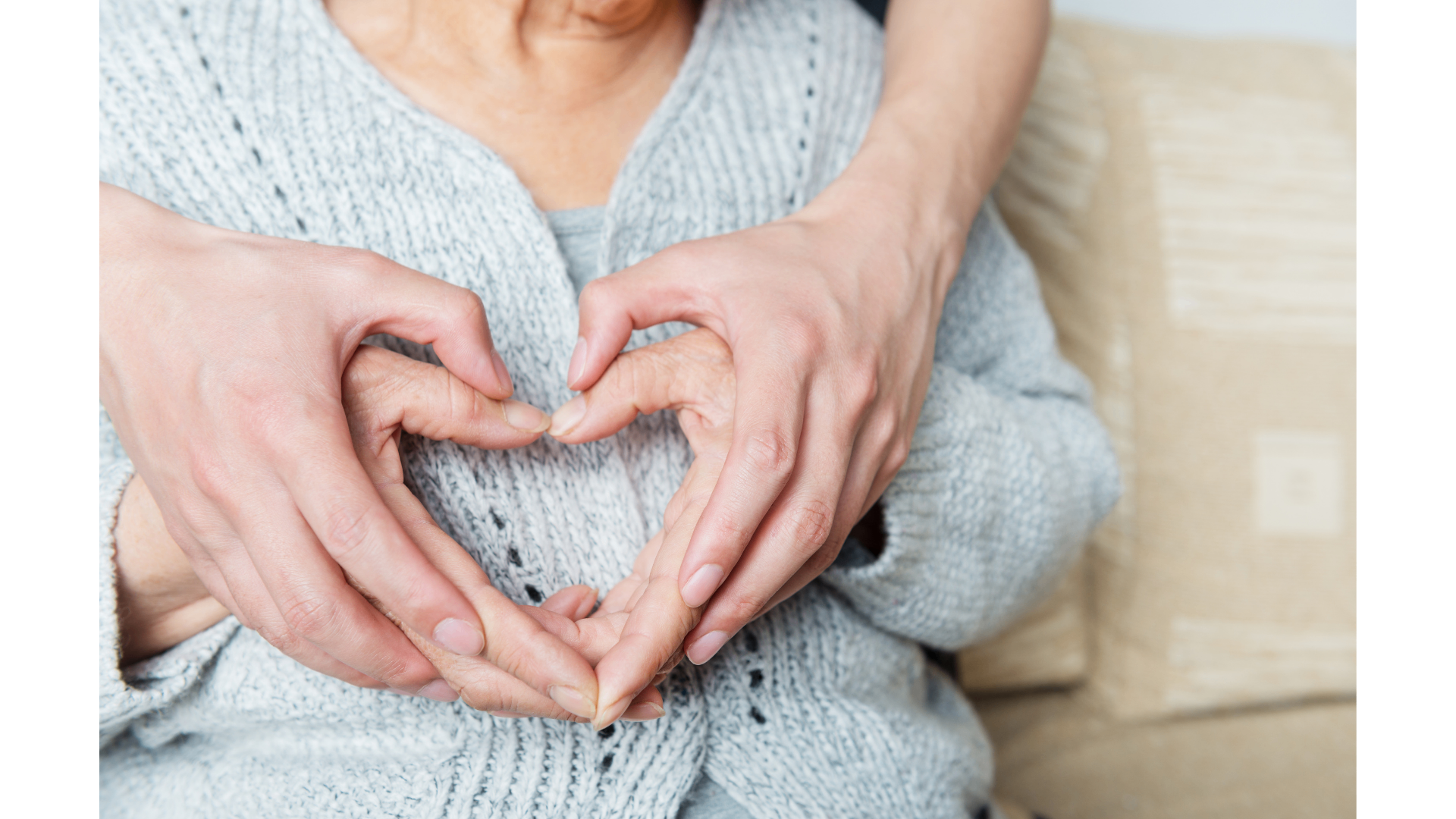 Two generations of hands forming a heart